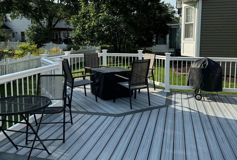 Gray Composite Deck Surface With Patio Furniture And White Railing