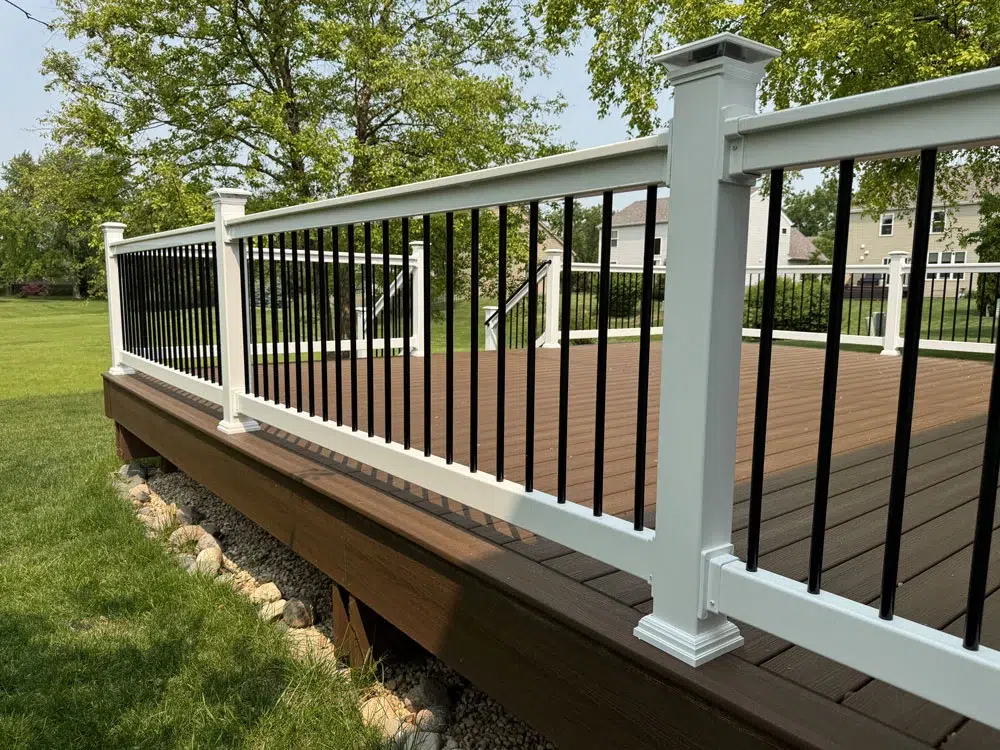 Two-Tone Composite Deck With White Railing And Black Aluminum Balusters Built By Royal Deck Contractor