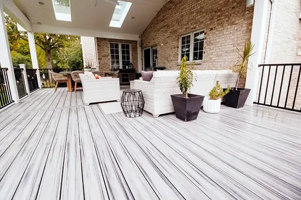Large composite deck with white wicker furniture Large Composite Deck With White Wicker Furniture