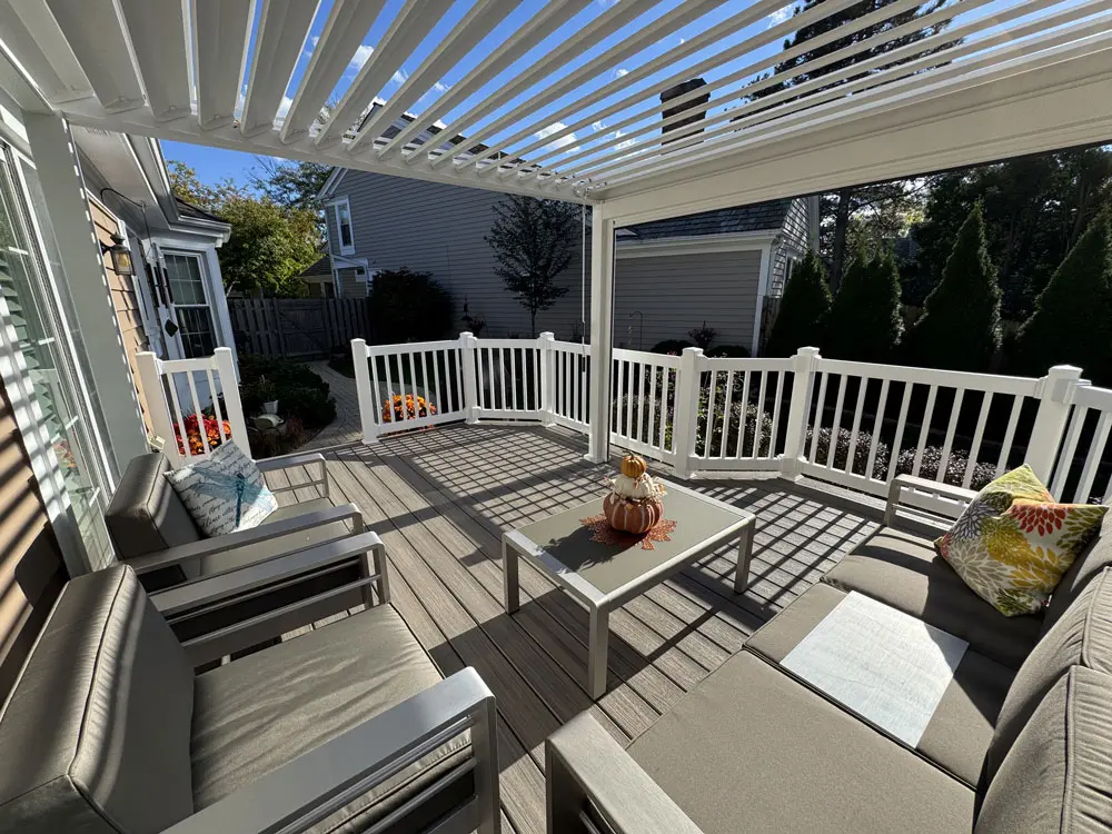 Louvered Pergola Over Deck Seating Area With Railing