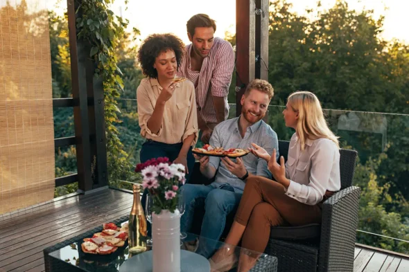 Relax, you're on weekend's time now Two Happy Couples Eating Pizza And Enjoying Sunny Afternoon At The Terrace